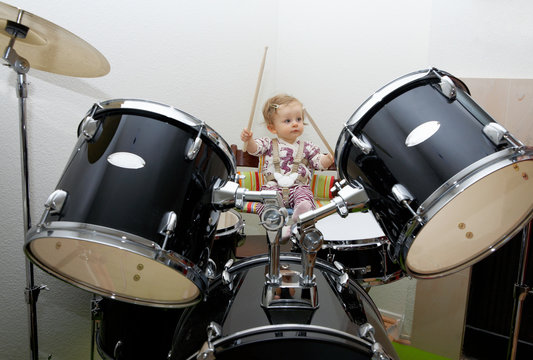 Baby girl playing drums