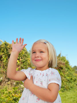 Young girl holding up hand