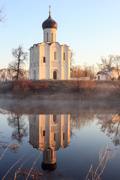 View to the Church of the Intercession of the Holy Virgin on the Nerl River in sunlight.