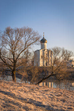 View to the Church of the Intercession of the Holy Virgin on the Nerl River in sunlight.