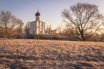 Horizontal view of an ancient church at dawn, a frosty morning, early spring