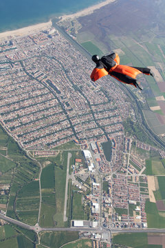 Man wingsuit flying over Empuriabrava, Spain