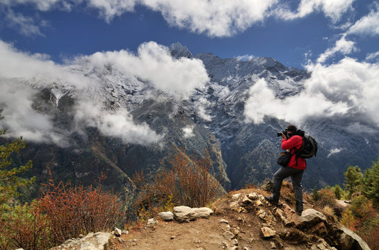 Photographer in the Himalayas on way from Namche Bazaar to Tengboche, Nepal