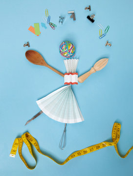 Household objects and stationery arranged against blue background