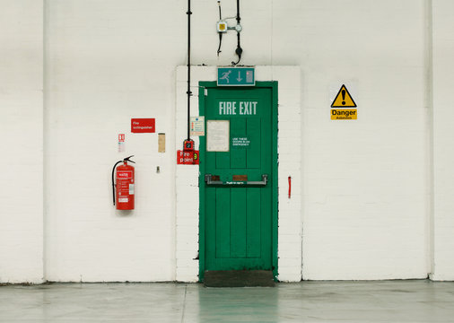 Fire exit door and signs in industrial building