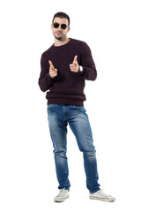 Friendly happy casual man choosing you pointing finger at camera. Full body length portrait isolated over white studio background.