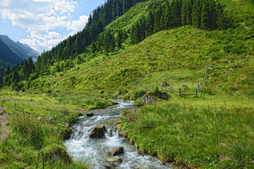 stream flowing through zillertal alps of tirol (austria)