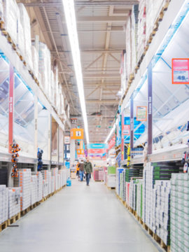 Blurred aisle with finishing materials in hardware store
