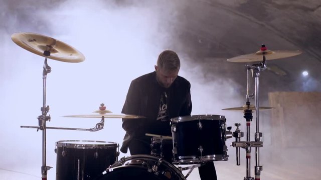 Young rock and roll drumer getting concetrated before start of the concert