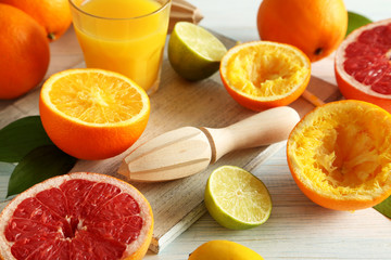 Citrus fruits with juicer on a blue wooden table