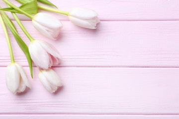 Fototapeta na wymiar Bouquet of tulips on pink wooden table