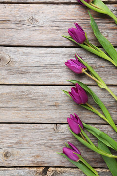 Bouquet of tulips on a grey wooden table
