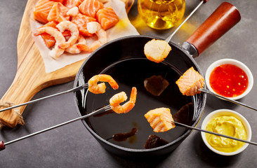 Healthy seafood fondue with dipping sauces