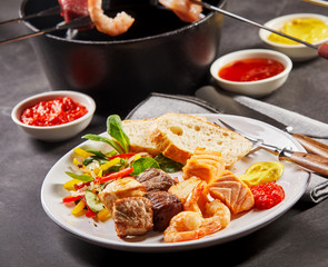 Serving of fresh fried seafood from a fondue