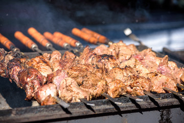 closeup of some meat skewers being grilled in a barbecue