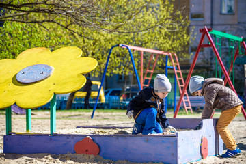 brothers are playing together on the playground