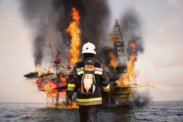 Firefighter in oil and gas industry with mission successful for protect with emergency case or...