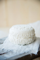 A goat cheese cut in half on a cutting board