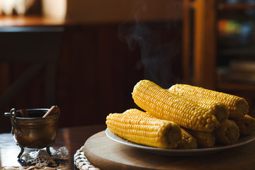 Boiled corn on a plate in the kitchen. © volurol