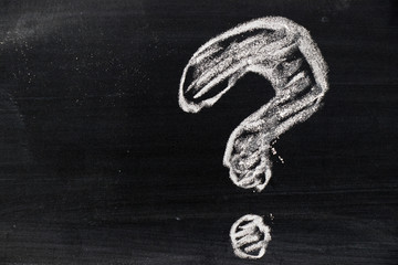 Chalk hand drawing as question mark shape on black board background