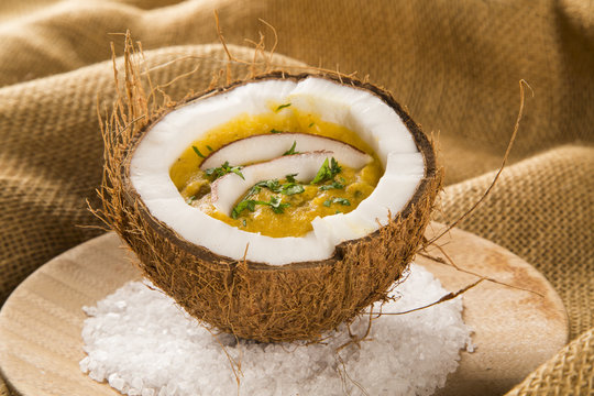 Sururu soup inside a coconut. Brazilian dish.