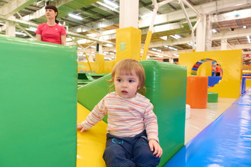 Fototapeta na wymiar The One Year Old Baby Cute Playing In Indoors Playground.