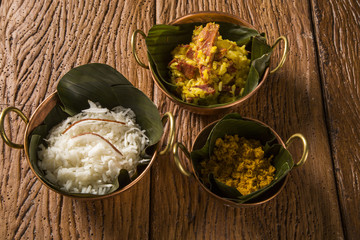 Rice with coconut, Yellow flour and  dried meat with rice in an old copper pot - Traditional bahia food