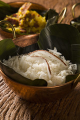 Rice with coconut in an old copper pot - Traditional bahia food