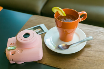 NAKHONRATCHASIMA, THAILAND - FEB 09, 2016 :Teapot and teacup in vintage style with pink camera.