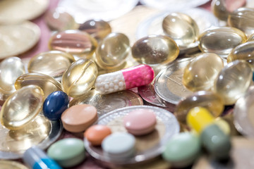 Fish oil pill, omega 3 with euro coin