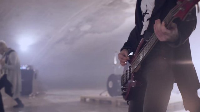 Rock and roll young guitarist with glasses fast playing guitar live with the band