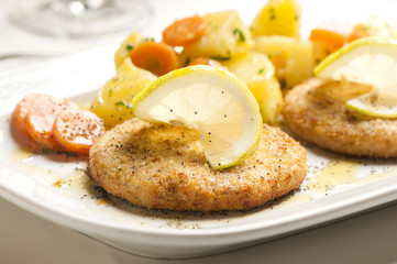 Fish Cake served on plate with lemon