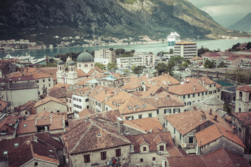Fototapeta na wymiar Kotor, Montenegro. Bay of Kotor bay is one of the most beautiful places on Adriatic Sea, it boasts the preserved Venetian fortress, old tiny villages, medieval towns and scenic mountains.