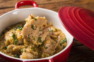 Brazilian dish canjiquinha or pela egua in red bowl.