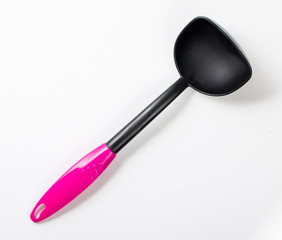Empty plastic black and pink spoon, scoop, ladle isolated on a white background, top view, close up.