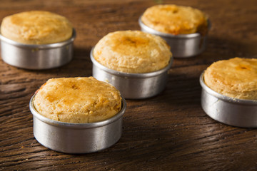 Empada Brazilian snack. pie with shrimp on wooden background