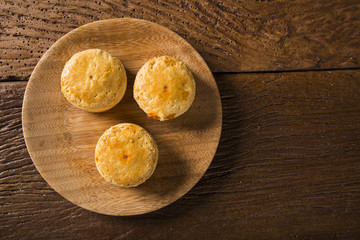 Empada Brazilian snack. pie with shrimp on wood plate on wooden background