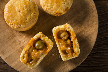 Empada Brazilian snack. pie with shrimp on wood plate on wooden background