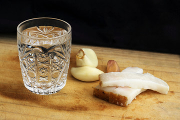 Glass of vodka on a table, country style.