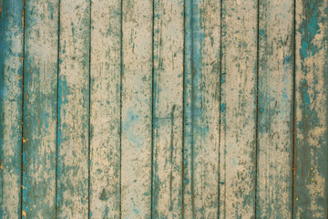 Green and light brown wooden texture background. Closeup of weathered painted wood planks of old house or barn. Horizontal color photography.