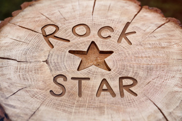 Rock star. Decorative inscription grunge wood carving. Beautiful textured background