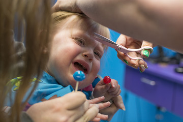Toddler crying during her first haircut