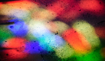 Colorful light spots on the tiled floor. Sunlight filtered through the stained glass window.