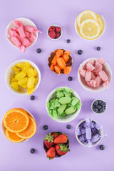 Candy and fruits on purple top