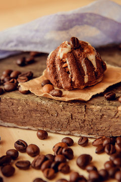 Chocolate cupcakes with coffee beans on dark background, AF point selection.