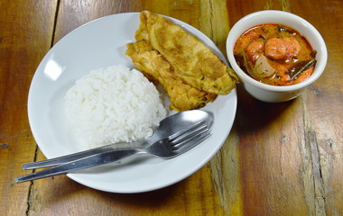 fried egg  on rice eat couple with spicy prawn Tom Yum soup