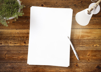 Blank document with pen on a wooden board 