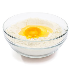 Flour with egg in glass bowl