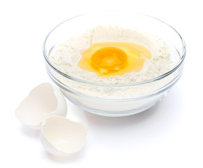 Flour with egg in glass bowl