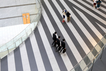 Team of businessman walking at modern office lobby
